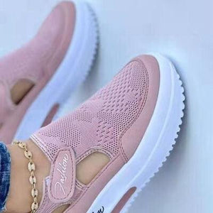 a pair of pink shoes with chains on them