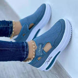 a woman's feet wearing blue shoes and jeans