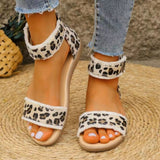 a close up of a person wearing leopard print sandals