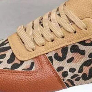 a pair of sneakers with a leopard print on them