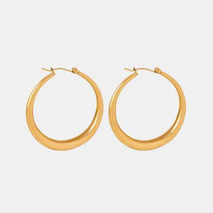 a pair of gold hoop earrings on a white background