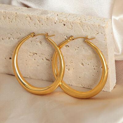 a close up of a pair of gold hoop earrings