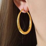 a close up of a person wearing a pair of earrings