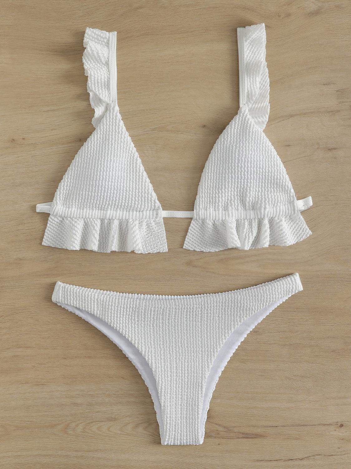 a white bikini top and bottom with ruffles