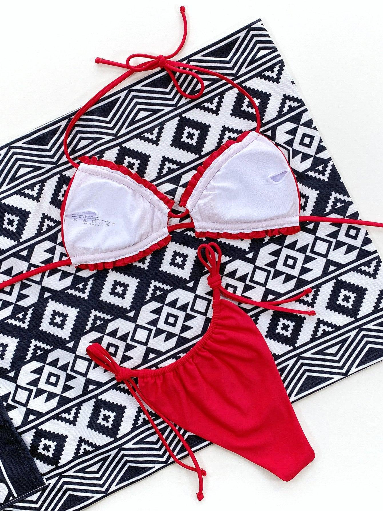 a red and white bikini top and a black and white towel