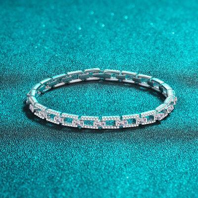 a diamond bracelet sitting on top of a blue surface