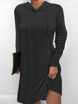 a woman wearing a black sweater dress