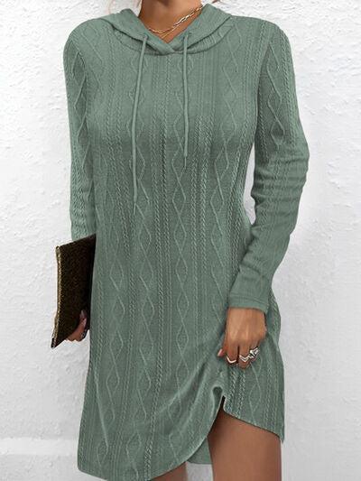 a woman wearing a green sweater dress