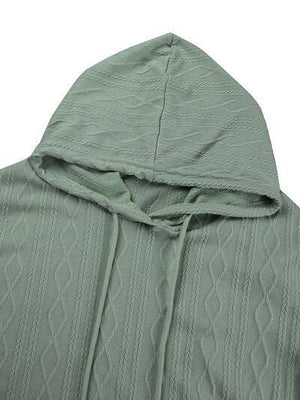 a green sweater with a hoodie on top of it