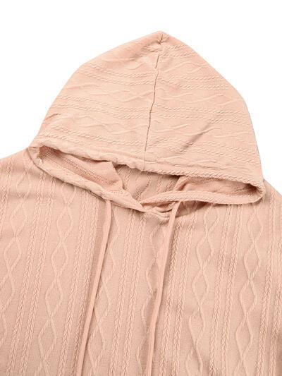 a pink sweater with a hoodie on top of it