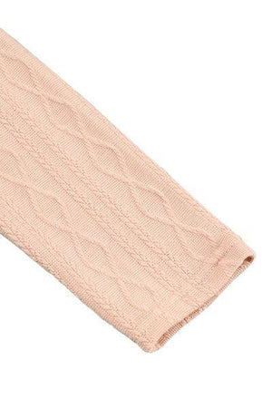 a pink knitted headband on a white background