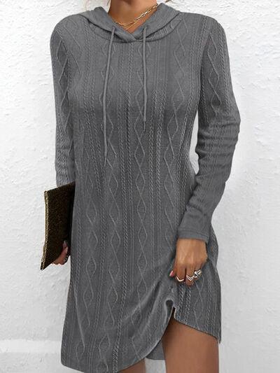 a woman wearing a gray sweater dress