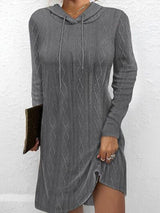 a woman wearing a gray sweater dress