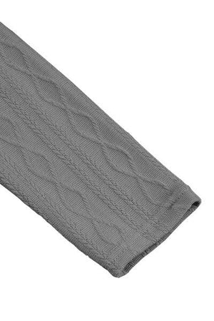 a gray cable knitted blanket on a white background