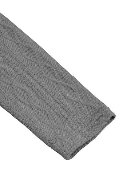 a gray cable knitted blanket on a white background