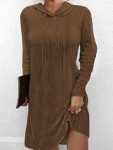 a woman wearing a brown sweater dress