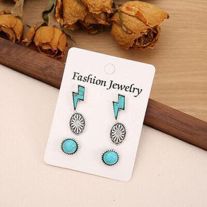 a pair of earrings sitting on top of a table