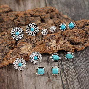 a group of turquoise stones sitting on top of a wooden table