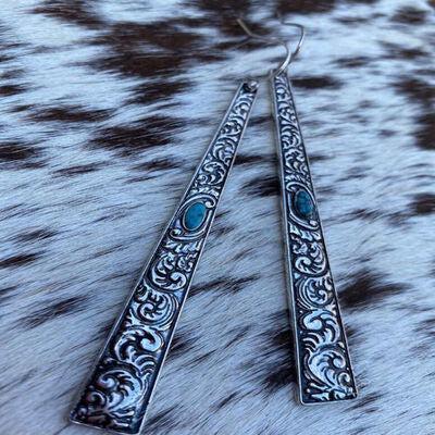 a pair of silver and turquoise stone earrings