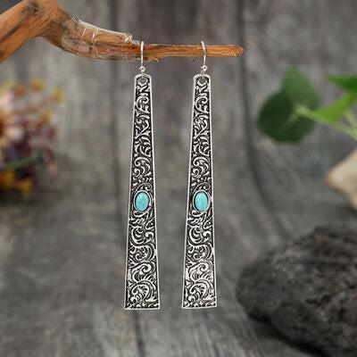 a pair of silver earrings with turquoise stones