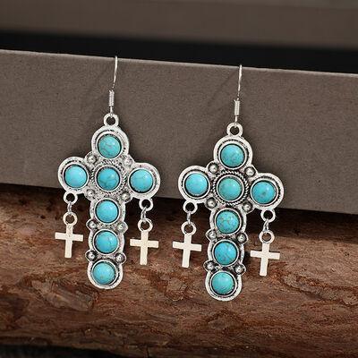 a pair of earrings with crosses and turquoise stones