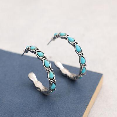 a pair of silver hoop earrings with turquoise stones