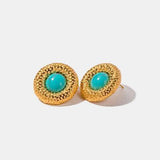 a pair of gold earrings with turquoise stones