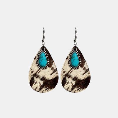 a pair of earrings with a turquoise stone