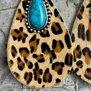 a pair of leopard print and turquoise stone earrings