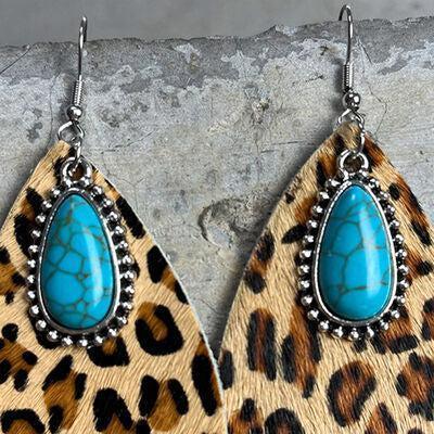 a pair of leopard print and turquoise stone earrings