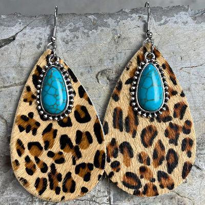 a pair of leopard print and turquoise stone earrings