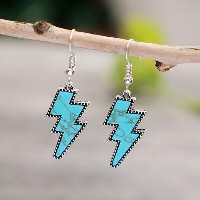 a pair of earrings with a turquoise and black design