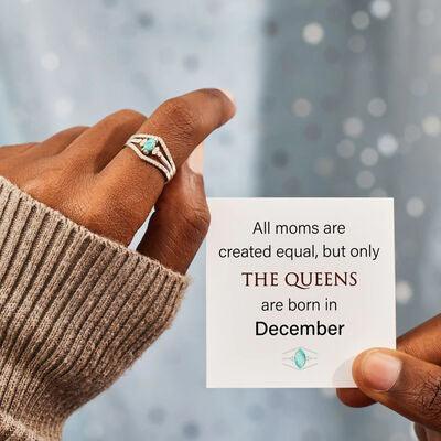 a person holding a card with a ring on it