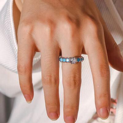 a close up of a person's hand with a ring on it