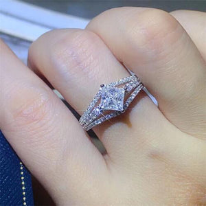 a woman's hand with a diamond ring on it