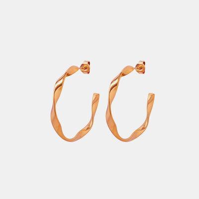 a pair of gold hoop earrings on a white background