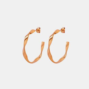 a pair of gold hoop earrings on a white background