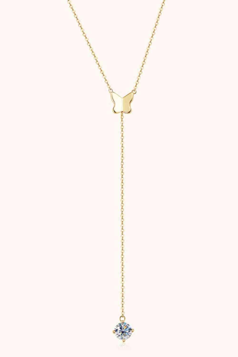 a gold necklace with a white diamond on a chain