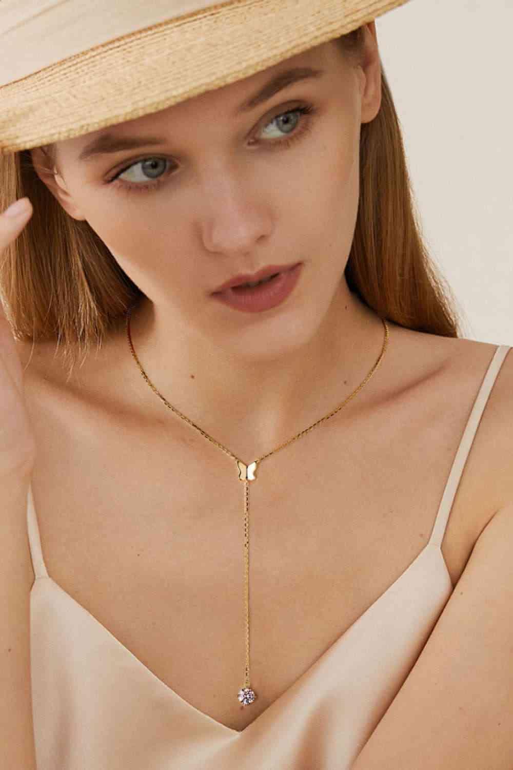 a woman wearing a hat and a necklace