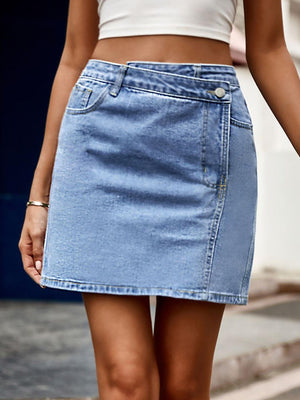 a woman walking down the street in a denim skirt