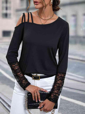 a woman wearing a black top and white pants