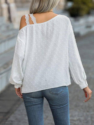 a woman wearing a white blouse and jeans