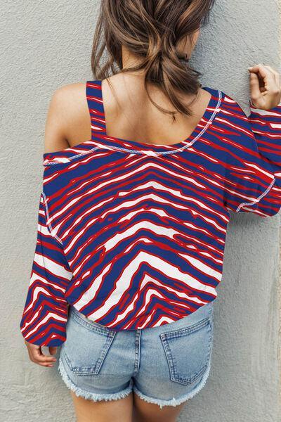 a woman wearing a red, white and blue striped top