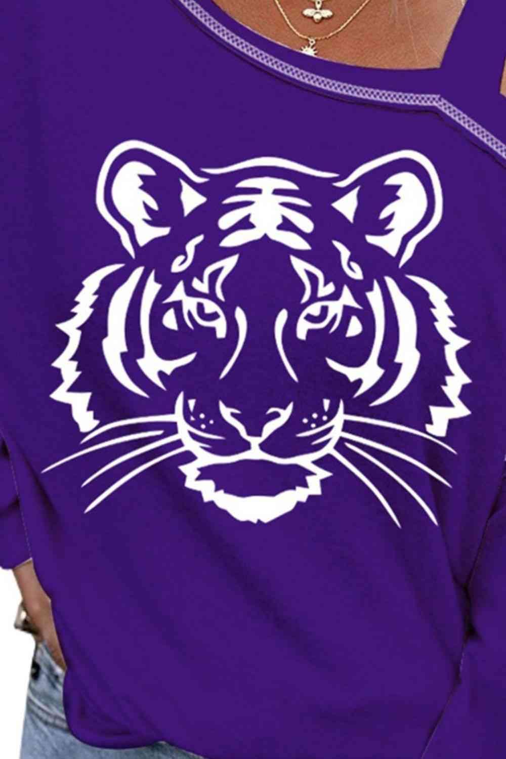 a woman wearing a purple tiger t - shirt