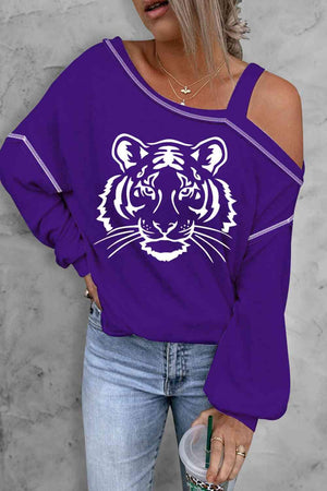a woman wearing a purple tiger sweatshirt