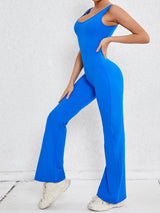 a woman in a blue jumpsuit posing for a picture