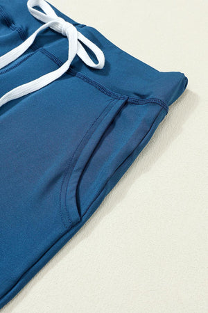 a close up of a blue sweat pants with white drawstrings