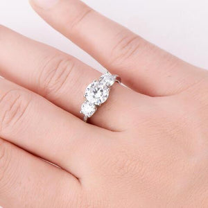 a woman's hand with a diamond ring on it