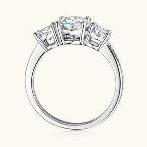 a three stone diamond ring on a white background