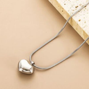 a heart shaped pendant on a necklace chain